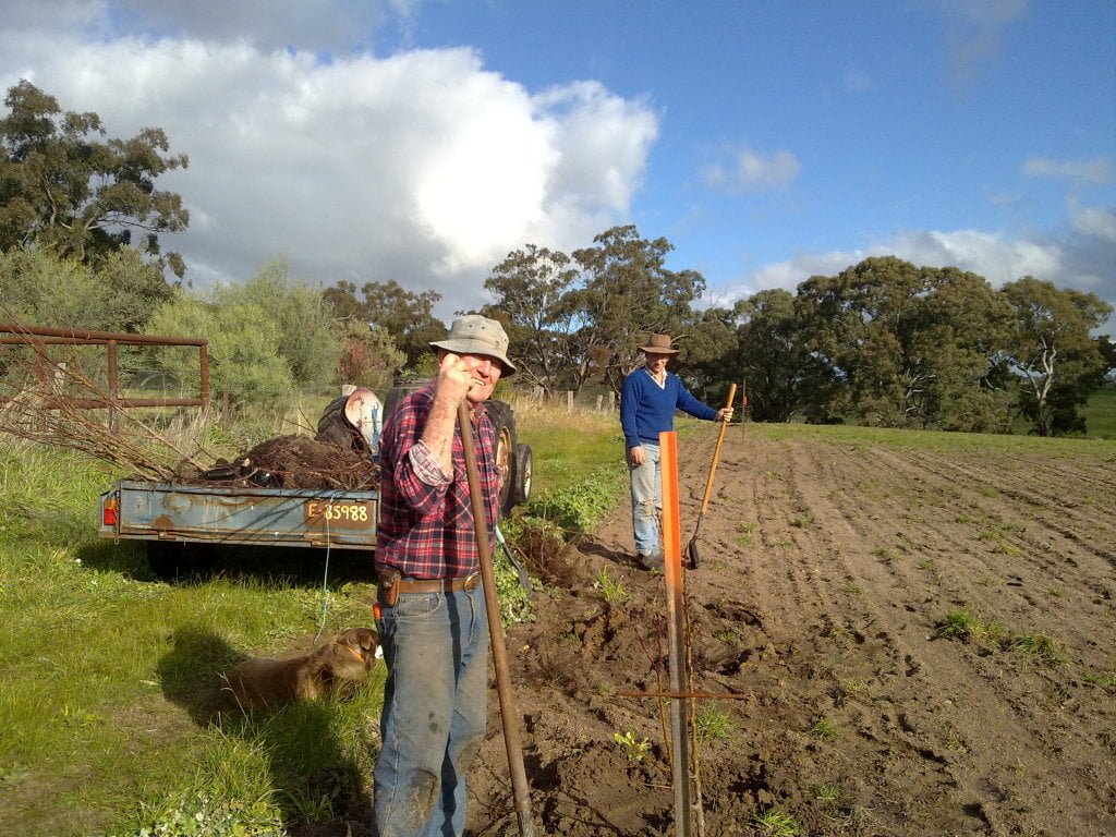Katie's dad and Hugh planting the new peach block, 2010