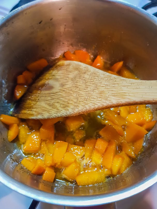 Apricots and sugar simmering to make the fruit sauce for dessert