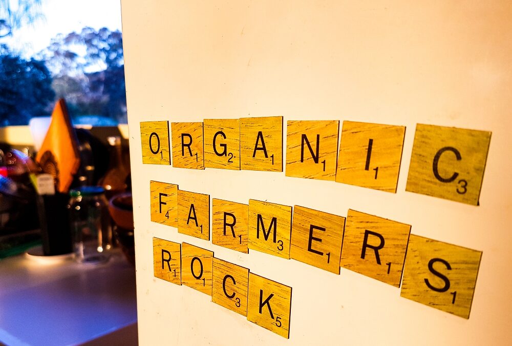 tiles on a fridge door spelling organic farmers rock